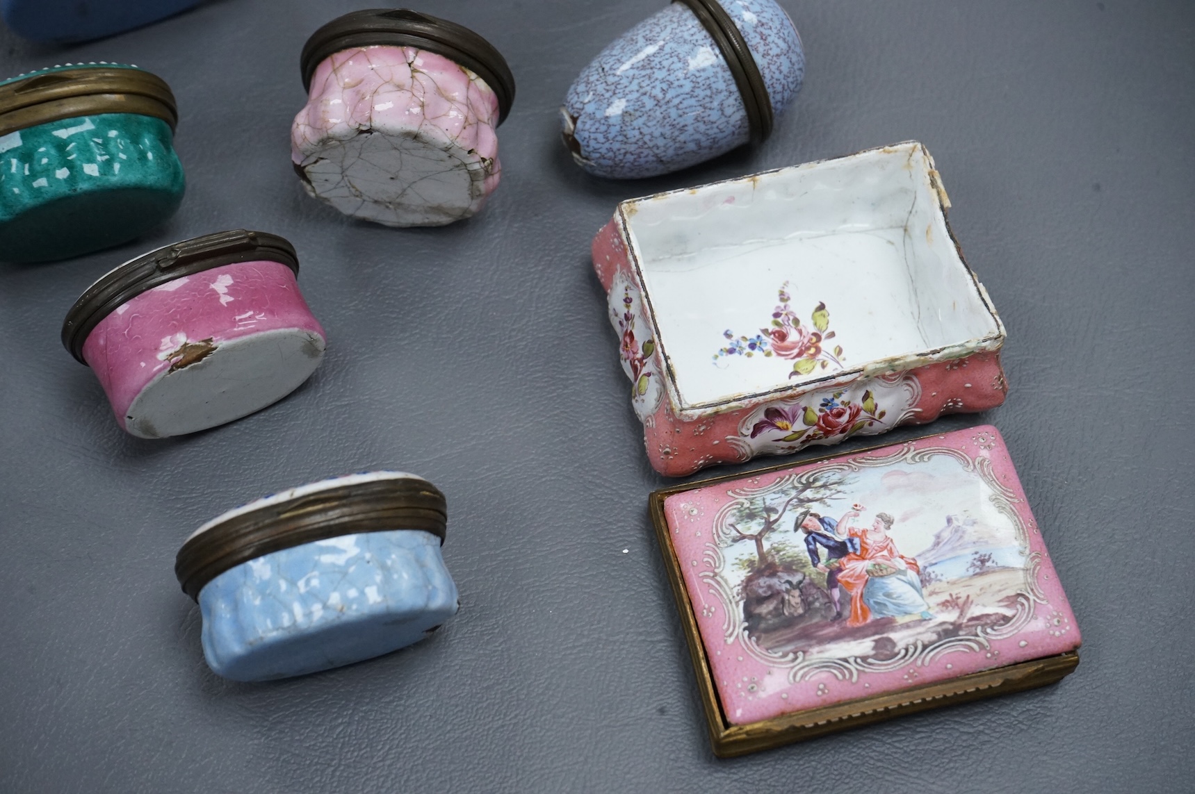 A collection of seven late 18th / early 19th century South Staffordshire enamel patch and snuff boxes and a continental porcelain snuff box, Largest 3.5cm high (8)